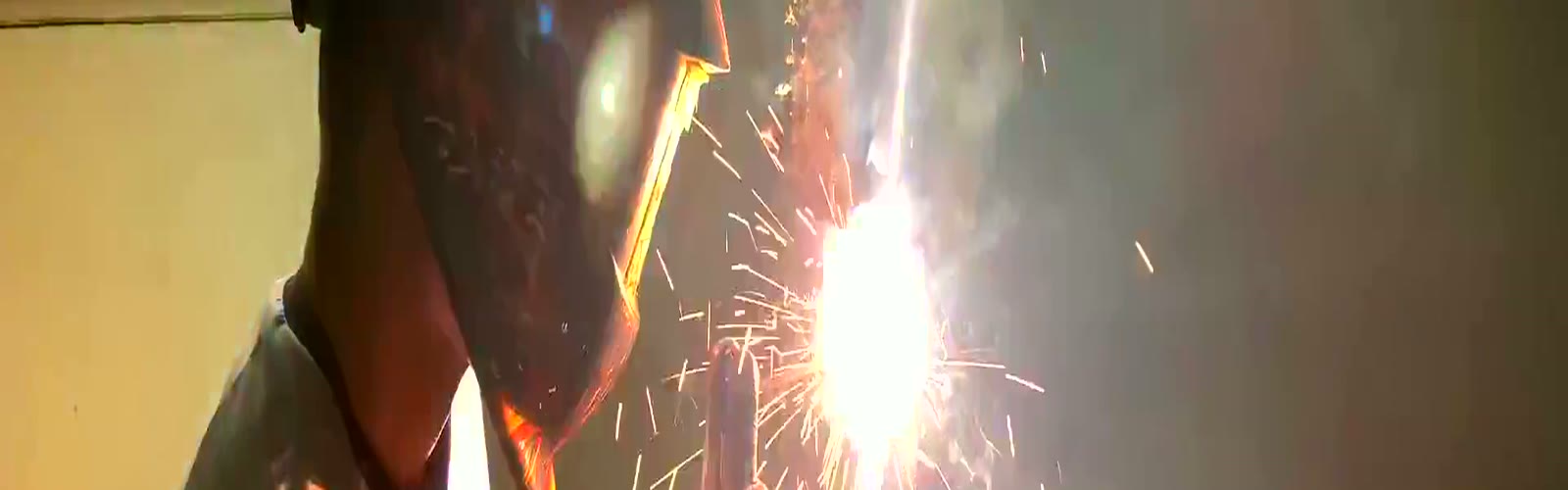 Stick-welding arc throwing sparks across the Jacksonville floor