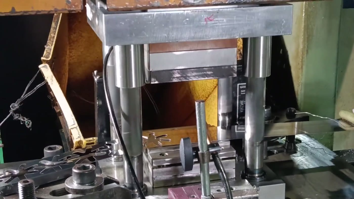 Four-post hydraulic press: chrome ram, milled platen and ejector nameplate on the Emory press floor