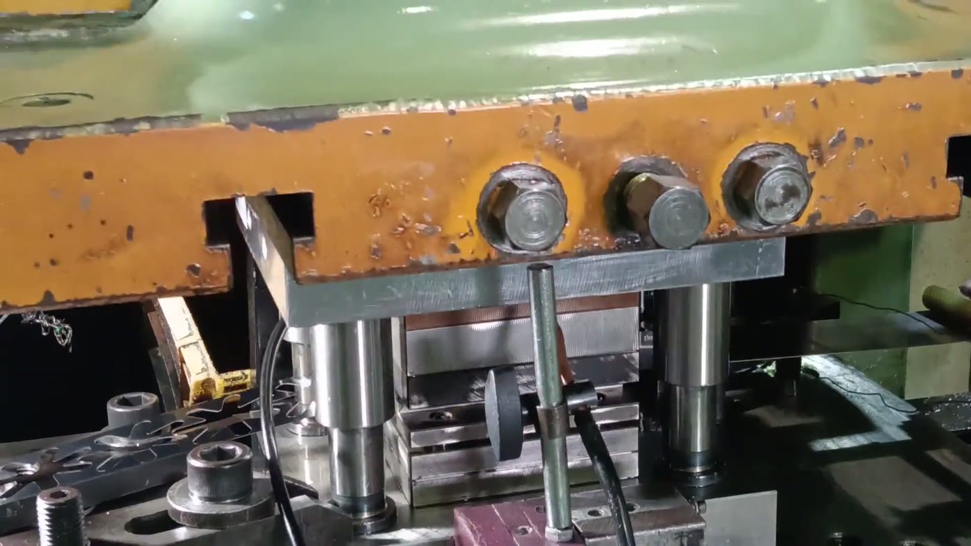 Progressive die press forming sheet-metal parts, stamped pieces on the bolster